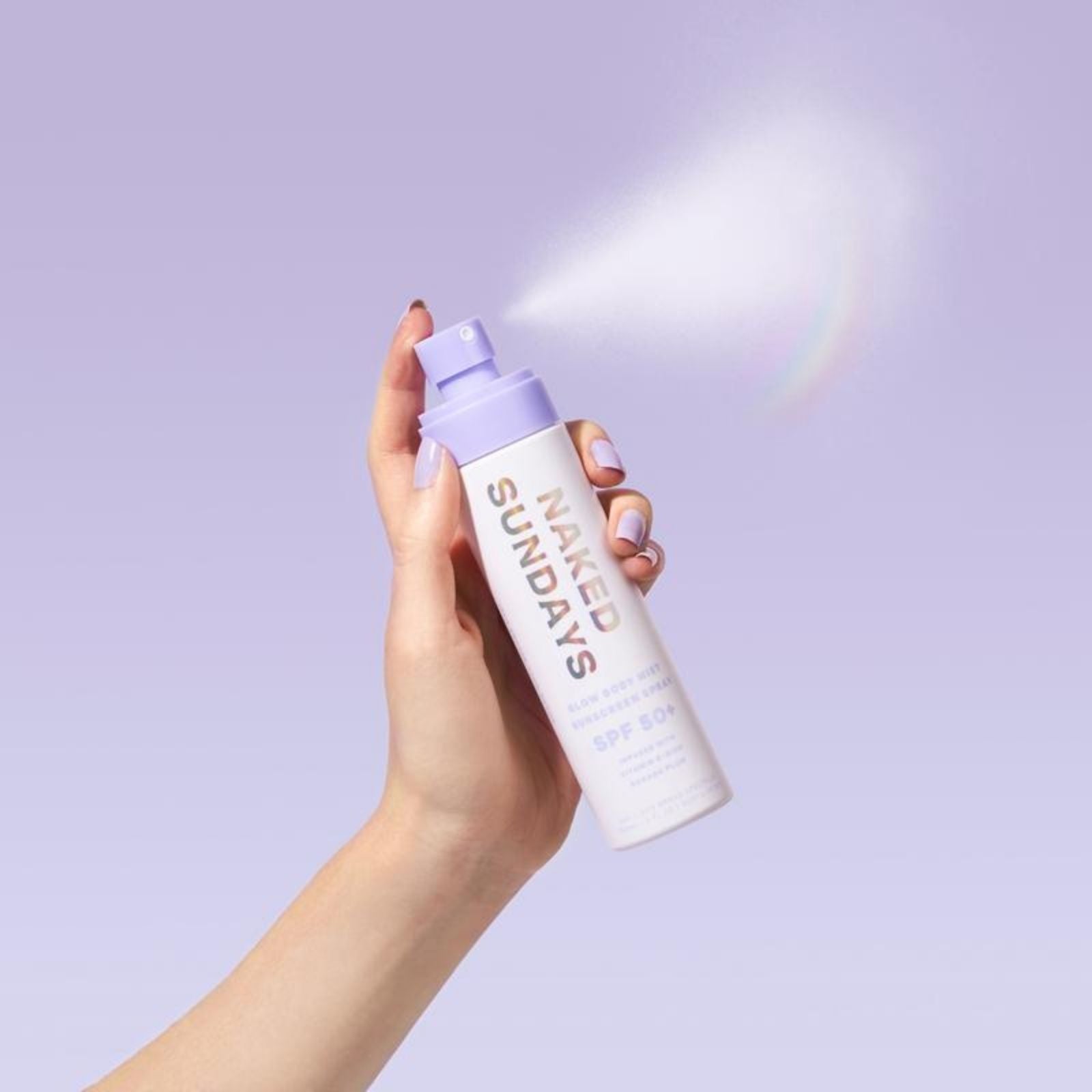 Glow Body Mist Sunscreen Spray held in hand and spraying